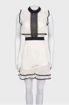 Beige dress decorated with perforations