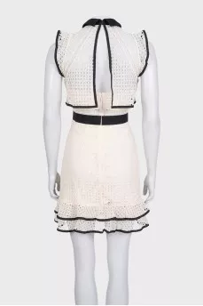 Beige dress decorated with perforations