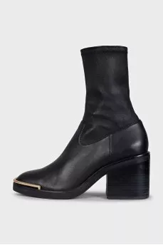 Black ankle boots with gold embellishments on the front