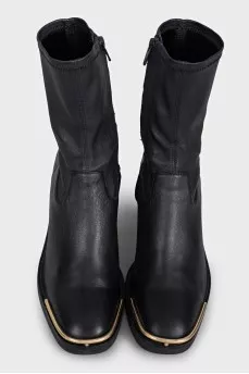 Black ankle boots with gold embellishments on the front