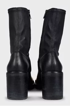 Black ankle boots with gold embellishments on the front
