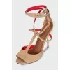 Suede sandals with leather inserts and a shaped heel