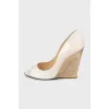 Beige sandals with a gold wedge heel