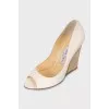 Beige sandals with a gold wedge heel