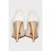 Beige sandals with a gold wedge heel