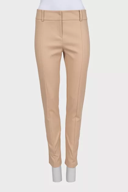 Beige tapered trousers with creases at the front