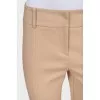 Beige tapered trousers with creases at the front
