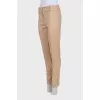 Beige tapered trousers with creases at the front