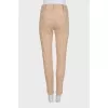 Beige tapered trousers with creases at the front