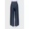 Wide-leg trousers with creases and tag