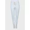 Tapered trousers decorated with lace