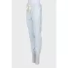 Tapered trousers decorated with lace