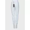 Tapered trousers decorated with lace