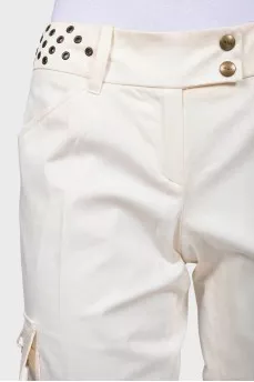 Flared trousers decorated with eyelets