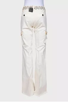 Flared trousers decorated with eyelets