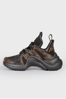 Black-brown leather sneakers with a bend on the sole