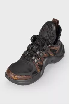Black-brown leather sneakers with a bend on the sole