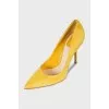 Yellow suede pumps