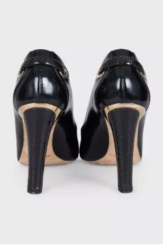 Black leather shoes with gold decor