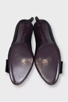 Black suede shoes with a bow