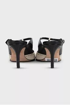 Beige leather mules decorated with perforations