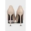 Beige high-heeled pumps
