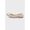 Beige ballet flats decorated with a flower
