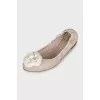 Beige ballet flats decorated with a flower