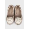 Beige ballet flats decorated with a flower