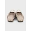 Beige ballet flats decorated with a flower