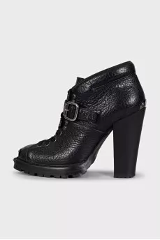 Black ankle boots with toe hardware