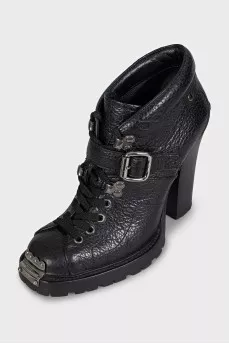 Black ankle boots with toe hardware