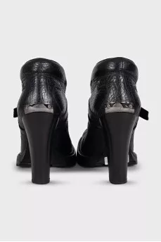Black ankle boots with toe hardware