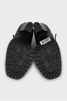 Black ankle boots with toe hardware