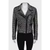 The leather jacket is decorated with rivets