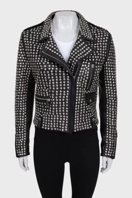 The leather jacket is decorated with rivets