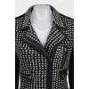 The leather jacket is decorated with rivets