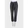 Cropped jeans with a rhinestone-embellished belt