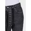 Cropped jeans with a rhinestone-embellished belt