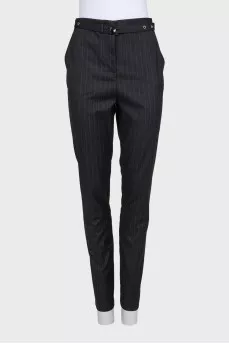 Tapered trousers with pinstripes and a belt