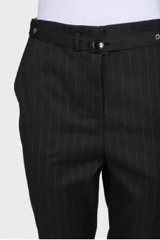 Tapered trousers with pinstripes and a belt