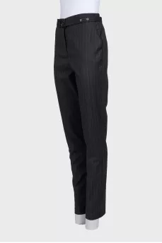 Tapered trousers with pinstripes and a belt