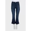 Blue flared jeans with a button