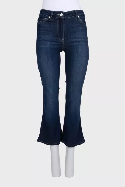 Blue flared jeans with a button
