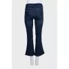 Blue flared jeans with a button