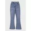 Light blue flared jeans with gold hardware