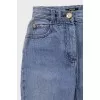 Light blue flared jeans with gold hardware
