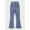 Light blue flared jeans with gold hardware