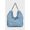 Denim bag decorated with fringe