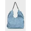 Denim bag decorated with fringe